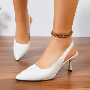 Close-up detail of elegant white patent leather pointed-toe slingback stiletto pumps