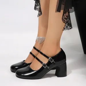 Détail de chaussures Mary Jane en cuir verni noir avec doubles brides et talon bloc.