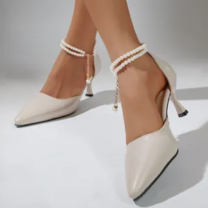 Elegant pointed-toe cream pumps featuring a stylish pearl ankle chain detail view.