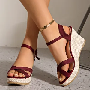 Elegant burgundy wedge sandals with straw-woven platform and ankle strap for summer.