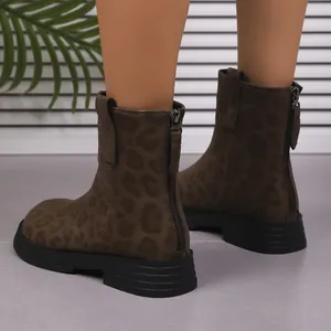 Detailed view of women's leopard print ankle boots featuring a back zipper and chunky sole