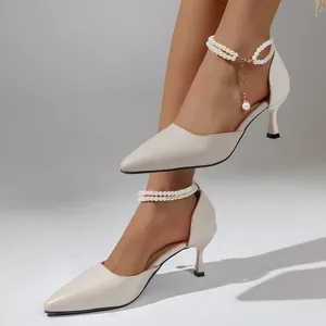 Elegant cream pointed-toe kitten heels featuring a delicate double pearl ankle strap detail.