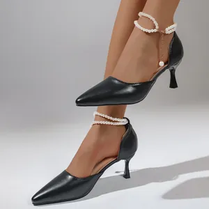 Elegant black pointed-toe high heels featuring decorative double-layer pearl ankle straps.