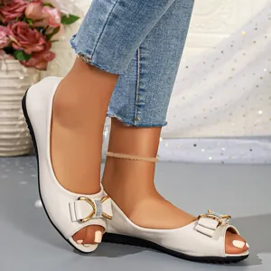 Close-up of elegant white peep-toe flat sandals featuring a decorative bow on a model