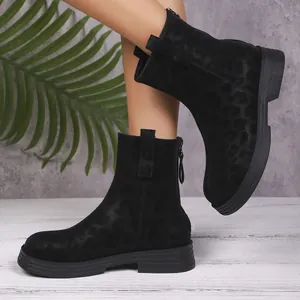 Detailed view of black leopard print ankle boots with back zipper and round toe.