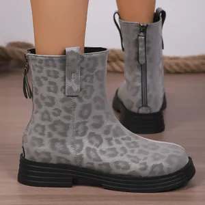 Chic grey leopard print ankle boots with platform soles and back zipper detail shown on feet