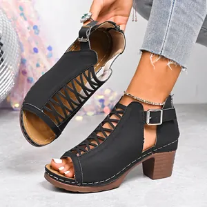 Detailed macro view of black chunky heel sandals with peep-toe and buckle design