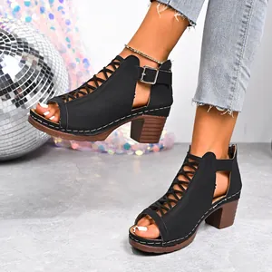 Detail view of black block heel sandals with lace-up front and ankle buckle strap