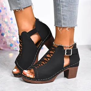 Close-up detail of stylish black chunky heel sandals featuring peep toe and buckle straps