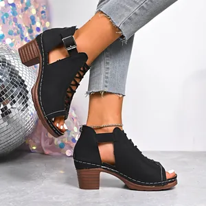 Detail of black peep-toe chunky heel sandals with buckle strap and stylish stitching