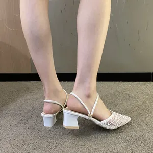 Detail view of white mesh pointed-toe sandals featuring mid-high chunky heels for women