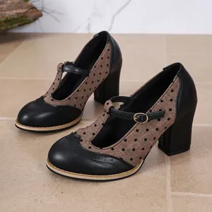 Side view of retro British style Mary Jane shoes with polka dot fabric and block heels