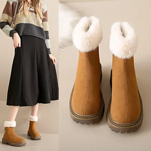 Vue détaillée de bottes de neige marron avec fourrure blanche et semelles épaisses antidérapantes.