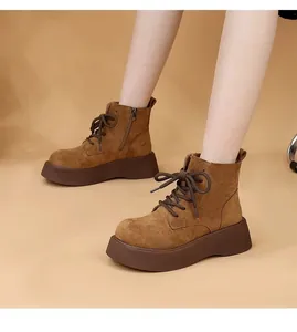 Detail shot of brown suede platform Martin boots with lace-up design