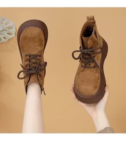 Detailed view of women's brown suede platform Martin boots with warm plush lining