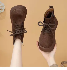 Detailed view of brown platform suede Martin boots with warm lining for winter.