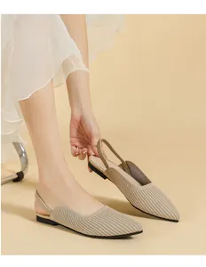 Close-up of beige pointed-toe knitted slingback flats with breathable ribbed texture
