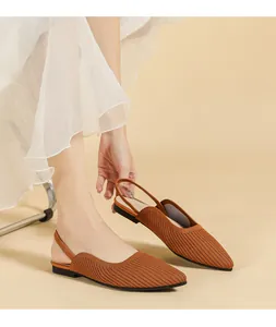 Detail view of elegant brown knitted pointed-toe slingback flats featuring soft breathable texture