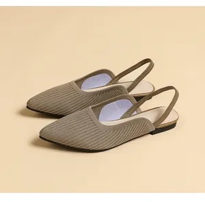 Detailed view of brown knit pointed-toe slingback flats with breathable texture.