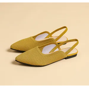 Detail of yellow knit pointed-toe slingback flats with breathable textured upper