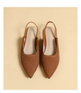 Detailed top view of brown knit pointed-toe slingback flats with a ribbed texture