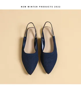 Top view detail showing the texture of dark blue knit pointed-toe flat slingback shoes.