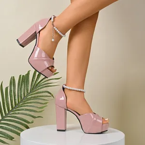 Pink patent leather platform sandals with chunky heels and elegant pearl ankle strap