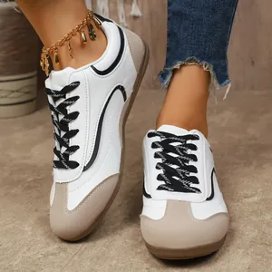 Vue détaillée de baskets pour femmes bicolores blanc et beige à lacets noirs