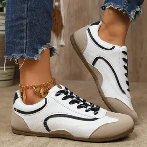 Gros plan de baskets de style GAT pour femmes avec lacets noirs et chevillère dorée