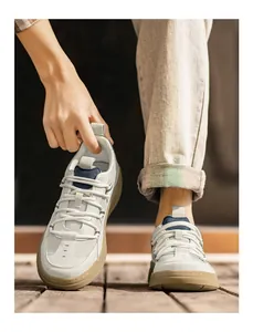 Detailed shot of men's retro German Army Trainers styled with casual denim jeans