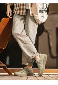 Detail shot of men's olive green retro German Army Trainers in a lifestyle setting