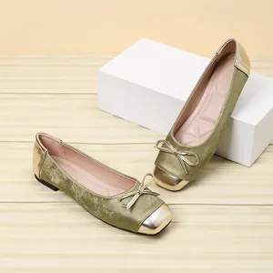 Close-up of olive green velvet ballet flats with gold square toe and bow detail