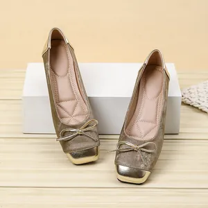 Detail of champagne gold square-toe ballet flats with bow and metallic toe