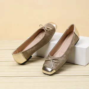 Detail shot of elegant square toe ballet flats with bow decoration and gold accents.