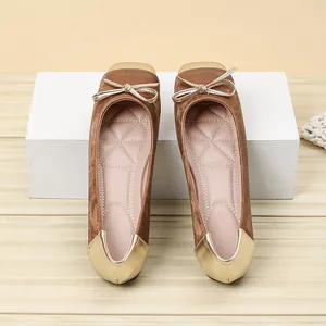 Top-down view of elegant brown velvet ballet flats with gold square toe and bow detail