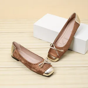 Detailed view of brown velvet ballet flats with gold metallic square toe and bow.