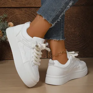 Detailed side view of women's white chunky platform sneakers with thick rope laces