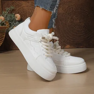 Close-up of white platform chunky sneakers with stylish rope laces and wavy stitching