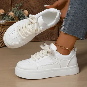 Close-up view of white platform bread sneakers featuring trendy thick cotton laces