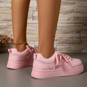 Detailed side view of pink platform bread shoes with thick woven laces on model