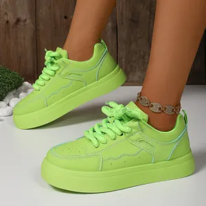 Detailed macro view of neon green chunky platform sneakers with thick laces on model