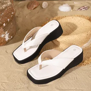 Stylish white platform thong sandals with square toe on professional beach sand background