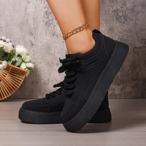 Close-up of black chunky platform sneakers with thick textured soles