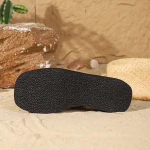 Close-up detail of the black textured non-slip sole on a stylish gold square-toe flip-flop