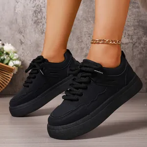 Detail view of black chunky platform bread shoes for women on a model's feet