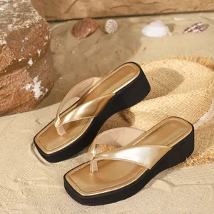Close-up of women's metallic gold platform flip-flops featuring a stylish square toe.