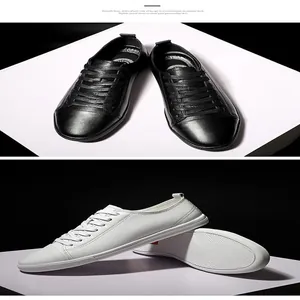 Detailed view of black and white leather sneakers highlighting texture and sole
