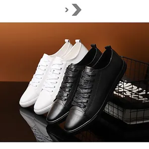 Detailed view of black and white leather casual sneakers for men in a studio setting