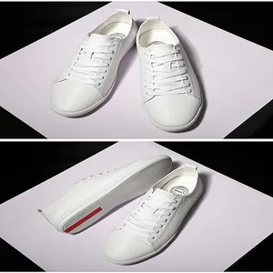 Detailed view of white leather sneakers showing the textured sole and comfort lining