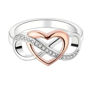 Bague élégante en argent avec cœur en or rose et motif infini serti de cristaux
